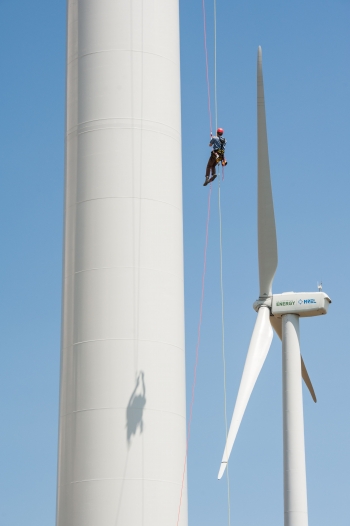 In this August 2013 photo, Pete Johnson of Gemini Rope Access Solutions rappels down a 3 megawatt Alstom wind turbine, just having finished inspecting the blades above him. The turbine was undergoing testing at NREL's National Wind Technology Center in Boulder, Colorado. | Photo courtesy of Dennis Schroeder, NREL. In this August 2013 photo, Pete Johnson of Gemini Rope Access Solutions rappels down a 3 megawatt Alstom wind turbine, just having finished inspecting the blades above him. The turbine was undergoing testing at NREL's National Wind Technology Center in Boulder, Colorado. | Photo courtesy of Dennis Schroeder, NREL.