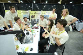⦠Will blow you away. This week, 150 students at 10 universities across the U.S. competed in the <a href="/node/909851">Collegiate Wind Competition</a>, which took place at the American Wind Energy Associationâs annual conference. Over the course of three intense days, the students put their wind turbines through rigorous performance testing, crafted their own business plans and pitched their turbine designs to wind industry leaders.
In this photo, students from James Madison University take a moment to discuss their strategies for the competition. Learn more about the <a href="http://www4.eere.energy.gov/wind/windcompetition/" target="_blank">Collegiate Wind Competition</a> and the <a href="http://www4.eere.energy.gov/wind/windcompetition/teams" target="_blank">participant teams here</a>. | Photo courtesy of the Energy Department. ⦠Will blow you away. This week, 150 students at 10 universities across the U.S. competed in the <a href="/node/909851">Collegiate Wind Competition</a>, which took place at the American Wind Energy Associationâs annual conference. Over the course of three intense days, the students put their wind turbines through rigorous performance testing, crafted their own business plans and pitched their turbine designs to wind industry leaders.
In this photo, students from James Madison University take a moment to discuss their strategies for the competition. Learn more about the <a href="http://www4.eere.energy.gov/wind/windcompetition/" target="_blank">Collegiate Wind Competition</a> and the <a href="http://www4.eere.energy.gov/wind/windcompetition/teams" target="_blank">participant teams here</a>. | Photo courtesy of the Energy Department.