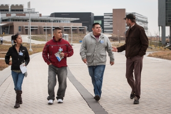 From left to right, Reyna Banteah, Shaun Tsabetsaye, and Jeremy Laselute of Zuni Pueblo, with NREL's Otto VanGeet. Photo by Dennis Schroeder, NREL From left to right, Reyna Banteah, Shaun Tsabetsaye, and Jeremy Laselute of Zuni Pueblo, with NREL's Otto VanGeet. Photo by Dennis Schroeder, NREL