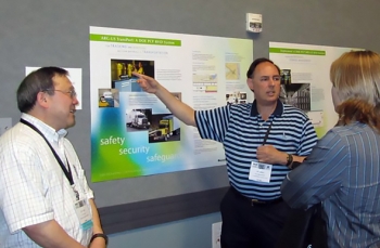 James Shuler, manager of DOEâs Packaging Certification Program, within EM's Office of Packaging and Transportation, discusses the radiofrequency identification technology he developed. At left is RFID Team Leader Yung Liu, with Argonne National Laboratory. James Shuler, manager of DOEâs Packaging Certification Program, within EM's Office of Packaging and Transportation, discusses the radiofrequency identification technology he developed. At left is RFID Team Leader Yung Liu, with Argonne National Laboratory.