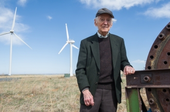 NREL Senior Engineer Palmer Carlin at the National Wind Technology Center, flanked by some of the massive turbines he says early wind technology pioneers only dreamed of seeing. | Photo by Dennis Schroeder NREL Senior Engineer Palmer Carlin at the National Wind Technology Center, flanked by some of the massive turbines he says early wind technology pioneers only dreamed of seeing. | Photo by Dennis Schroeder