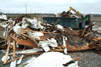 Workers cut up old trailers and placed them in containers so that the debris could be placed in the siteâs industrial landfill. Workers cut up old trailers and placed them in containers so that the debris could be placed in the siteâs industrial landfill.