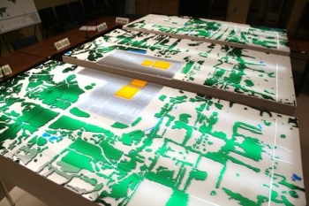 Shown at the Paducah Citizens Advisory Board office, this model depicts a 10-square-mile area around the Paducah site to a depth of several hundred feet. Yellow structures depict the siteâs four large uranium hexafluoride process buildings. Shown at the Paducah Citizens Advisory Board office, this model depicts a 10-square-mile area around the Paducah site to a depth of several hundred feet. Yellow structures depict the siteâs four large uranium hexafluoride process buildings.