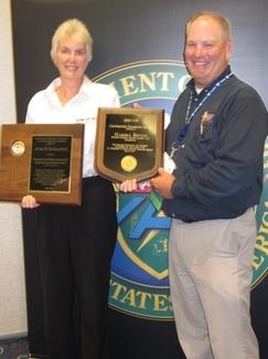 Wastren-EnergX Mission Support (WEMS) Senior Safety Engineer Marsha Bevins, left, stands with DOE Director of Worker Safety and Health Brad Davy while holding her Voluntary Protection Program Contractor Champion of the Year award and the 2012 Star of Excellence award WEMS received. Wastren-EnergX Mission Support (WEMS) Senior Safety Engineer Marsha Bevins, left, stands with DOE Director of Worker Safety and Health Brad Davy while holding her Voluntary Protection Program Contractor Champion of the Year award and the 2012 Star of Excellence award WEMS received.