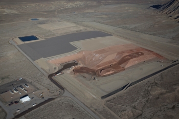View of the Crescent Junction disposal cell, looking northwest. From center left to right, the photo shows final cover, interim cover, tailings, and excavated cell ready to be filled. View of the Crescent Junction disposal cell, looking northwest. From center left to right, the photo shows final cover, interim cover, tailings, and excavated cell ready to be filled.