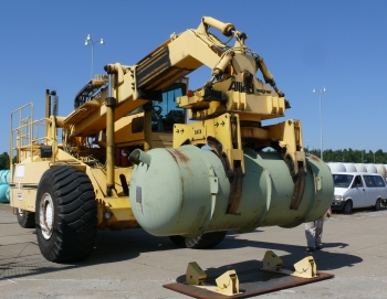 This cylinder hauler at Paducahâs Babcock & Wilcox Conversion Services plant delivers the first of DOEâs 14-ton depleted uranium cylinders to USEC for re-enrichment as part
of a five-party agreement that is extending enrichment operations at the 60-year-old plant for another year, delaying increased costs at the site for DOE. This cylinder hauler at Paducahâs Babcock & Wilcox Conversion Services plant delivers the first of DOEâs 14-ton depleted uranium cylinders to USEC for re-enrichment as part
of a five-party agreement that is extending enrichment operations at the 60-year-old plant for another year, delaying increased costs at the site for DOE.