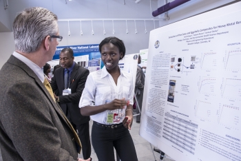 Benedict College student Faith Kibuye explains her researcher to SRNL Laboratory Director Dr. Terry Michalske Benedict College student Faith Kibuye explains her researcher to SRNL Laboratory Director Dr. Terry Michalske