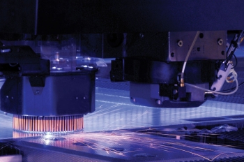 A combination solid-state laser turret cutter and stamping machine cuts a thin steel plate that will be formed into lighting fixture housing. Wisconsin-based Eaton Corporation is developing a new manufacturing process that streamlines LED fixture designs. | Photo courtesy of Eaton Corporation A combination solid-state laser turret cutter and stamping machine cuts a thin steel plate that will be formed into lighting fixture housing. Wisconsin-based Eaton Corporation is developing a new manufacturing process that streamlines LED fixture designs. | Photo courtesy of Eaton Corporation