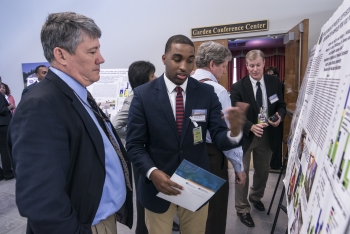 DOE Deputy Assistant Secretary Mark Gilbertson learns of research performed by South Carolina State student Andrew McCray DOE Deputy Assistant Secretary Mark Gilbertson learns of research performed by South Carolina State student Andrew McCray