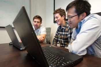 National Renewable Laboratory intern Chad Hotmimsky, center, looks at simulations of wave energy converters with research engineers Michael Lawson, left, and Yi-Hsiang Yu, right. The two engineers mentored Hotmimsky at the National Wind Technology Center. | Photo by Dennis Schroeder, National Renewable Laboratory National Renewable Laboratory intern Chad Hotmimsky, center, looks at simulations of wave energy converters with research engineers Michael Lawson, left, and Yi-Hsiang Yu, right. The two engineers mentored Hotmimsky at the National Wind Technology Center. | Photo by Dennis Schroeder, National Renewable Laboratory