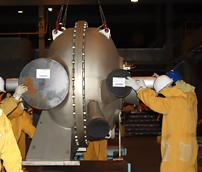 Workers guide a compressor during a lift from the former uranium enrichment cascade in the X-326 Process Building at EMâs Portsmouth Gaseous Diffusion Plant in Piketon. The first shipment of the components, which were used for 60 years, was completed in January as part of cleanup operations under way at the EM facility. Workers guide a compressor during a lift from the former uranium enrichment cascade in the X-326 Process Building at EMâs Portsmouth Gaseous Diffusion Plant in Piketon. The first shipment of the components, which were used for 60 years, was completed in January as part of cleanup operations under way at the EM facility.