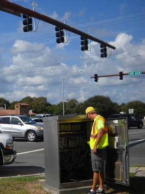 A worker synchronizes a traffic light on State Road A1A in St. Augustine, FL. | Energy Department Photo | A worker synchronizes a traffic light on State Road A1A in St. Augustine, FL. | Energy Department Photo |