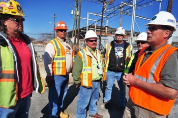 Jim (far right) talks with workers at the K-25 demolition site. Jim (far right) talks with workers at the K-25 demolition site.
