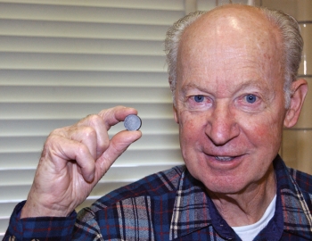 Dr. Karl Gschneidner is holding a neodymium-iron-boron magnet produced using a new, greener process. The process that Dr. Gschneidner helped develop doesnât produce the environmentally unfriendly byproducts that result from traditional manufacturing methods. | Photo courtesy of Ames Laboratory. Dr. Karl Gschneidner is holding a neodymium-iron-boron magnet produced using a new, greener process. The process that Dr. Gschneidner helped develop doesnât produce the environmentally unfriendly byproducts that result from traditional manufacturing methods. | Photo courtesy of Ames Laboratory.