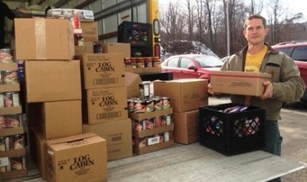 Volunteer John Schelble helps unload a delivery truck at a food pantry. Volunteer John Schelble helps unload a delivery truck at a food pantry.
