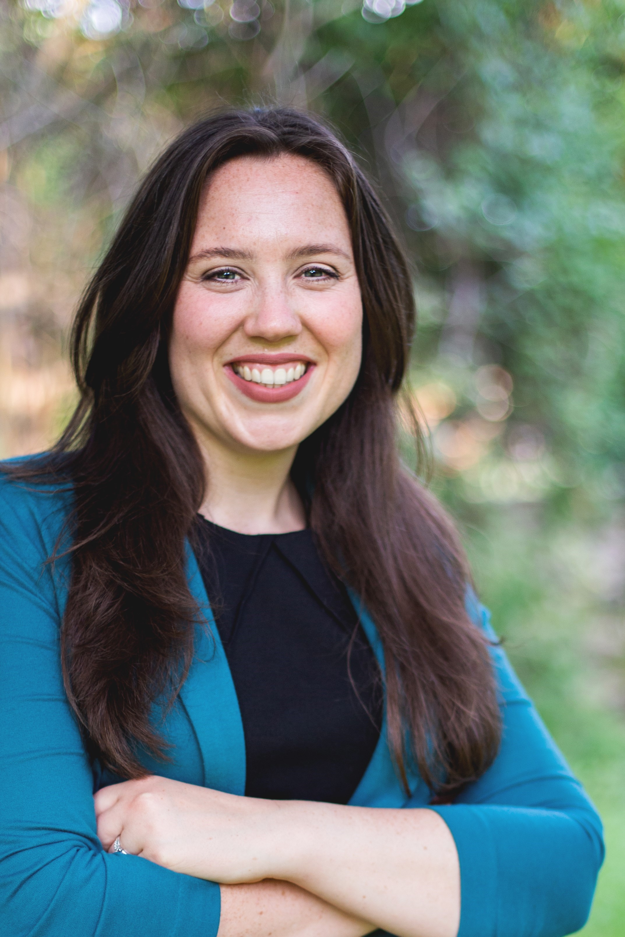 Headshot of a. Hannah Debelius in an outdoor setting.