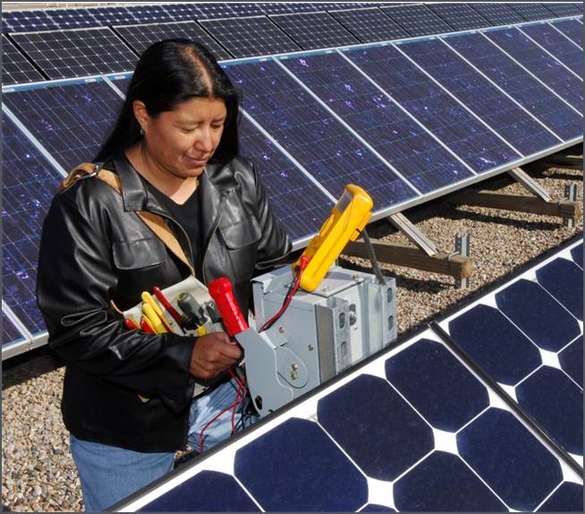 An engineer uses tools to work on a solar panel array