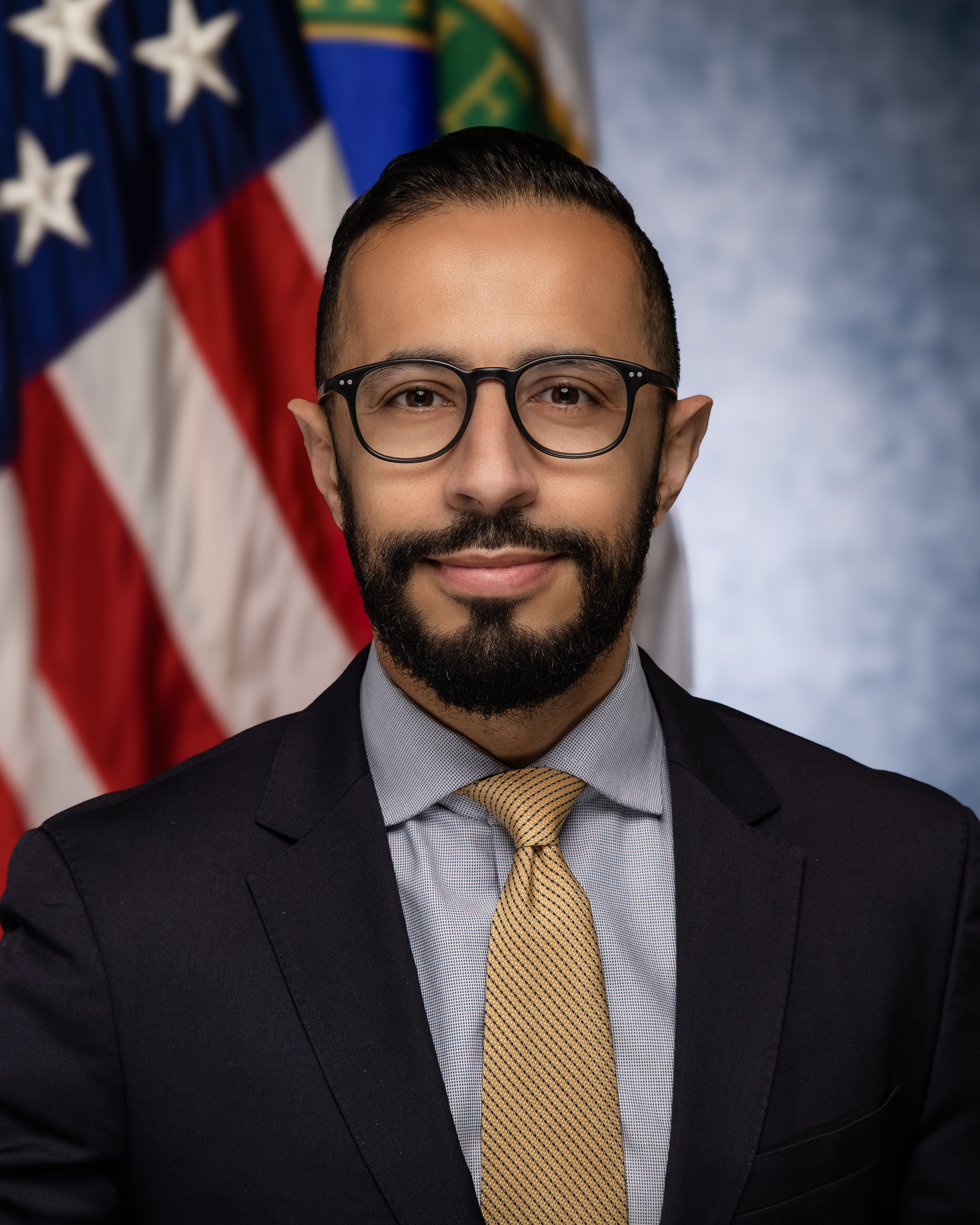 Portrait of man in front of the United States flag.