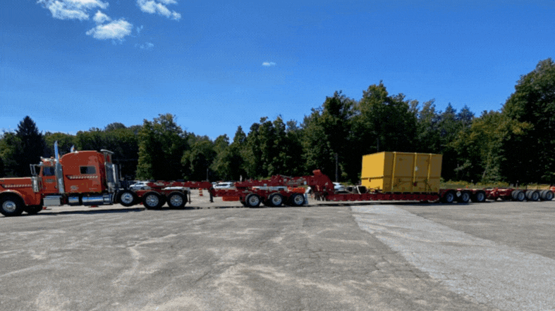 Trucks carrying heavy containers of legacy waste are shipped on to an offsite disposal location.