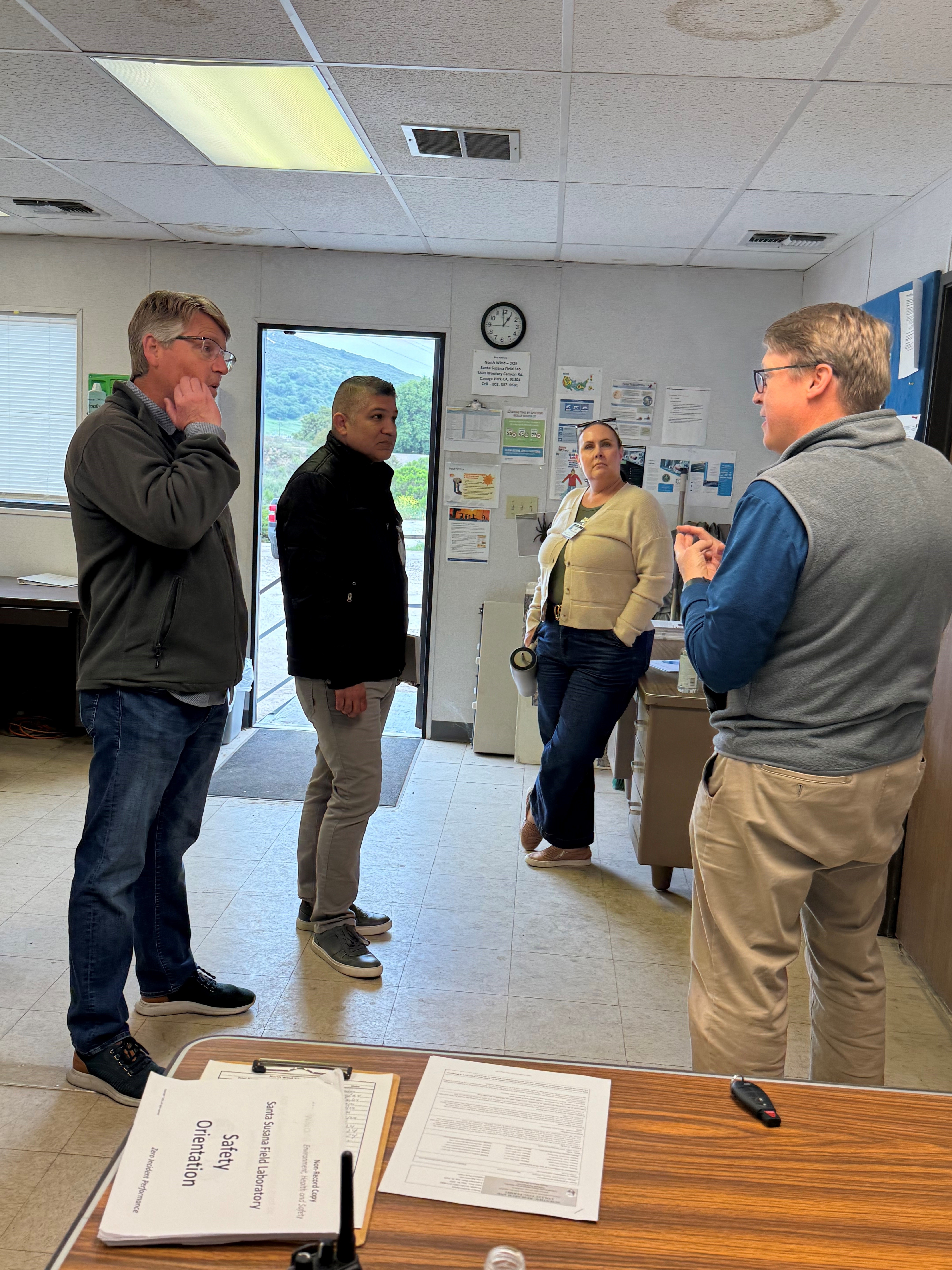 Four employees within a meeting room