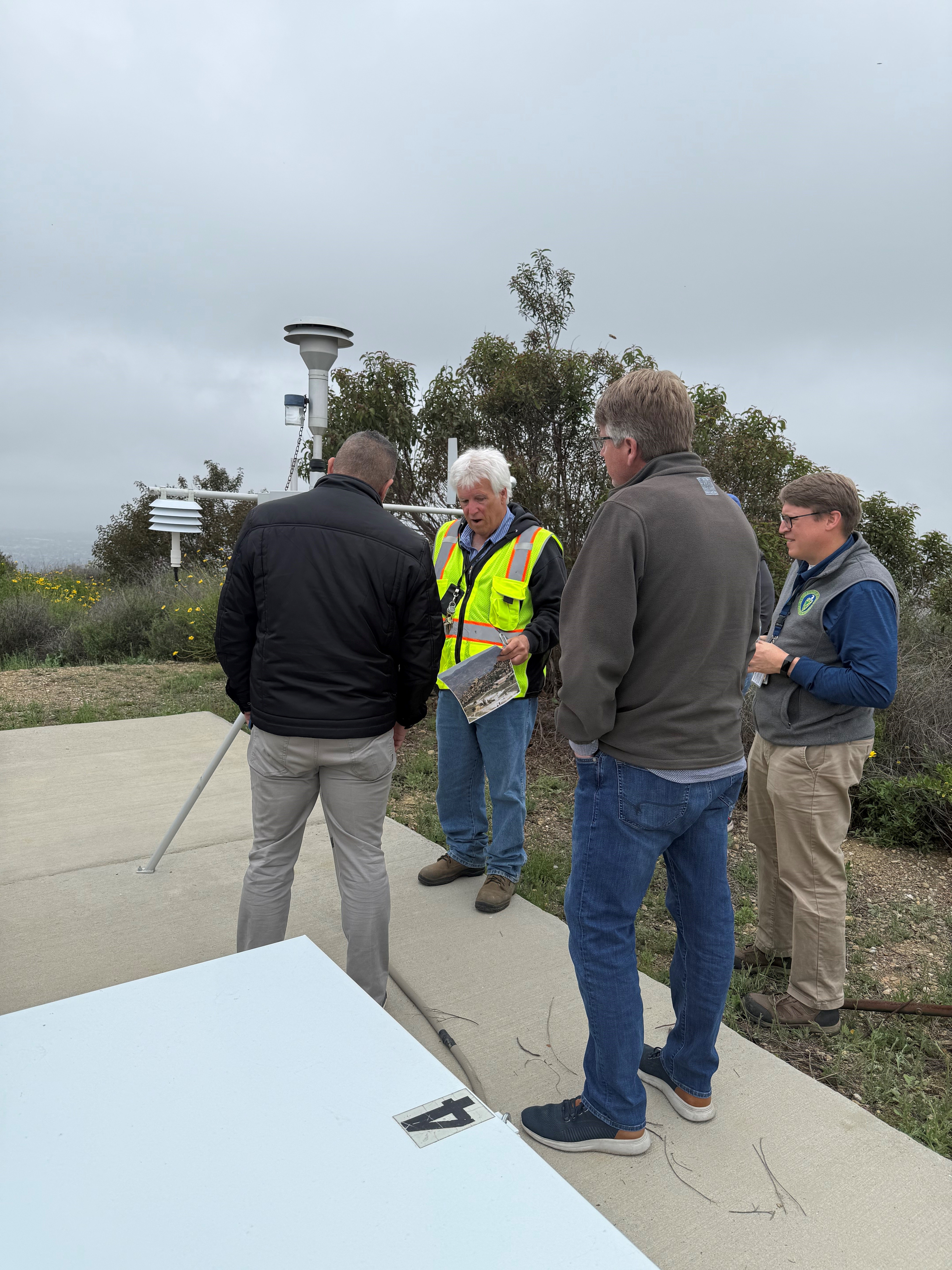 Employees and local officials tour a site