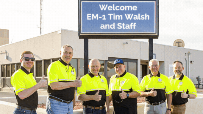 Rotating set of images of EM leadership touring the WIPP site