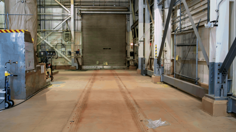 A rotating set of images of before and after recovery of a rail system inside a facility building