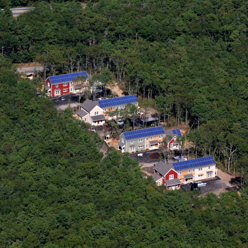 aerial shots of homes with solar panels on their roof.