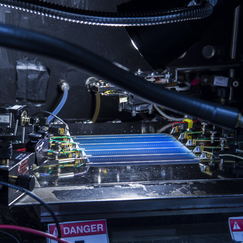 Paul Ndione from the Cell Performance Measuring group at NREL, measures a cell's efficiency using the X25 Solar Simulator in their lab at the SERF.