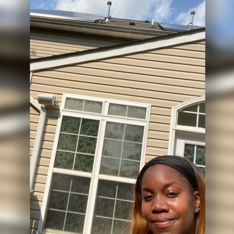 Selfie of Lakisha Harris with her rooftop solar system
