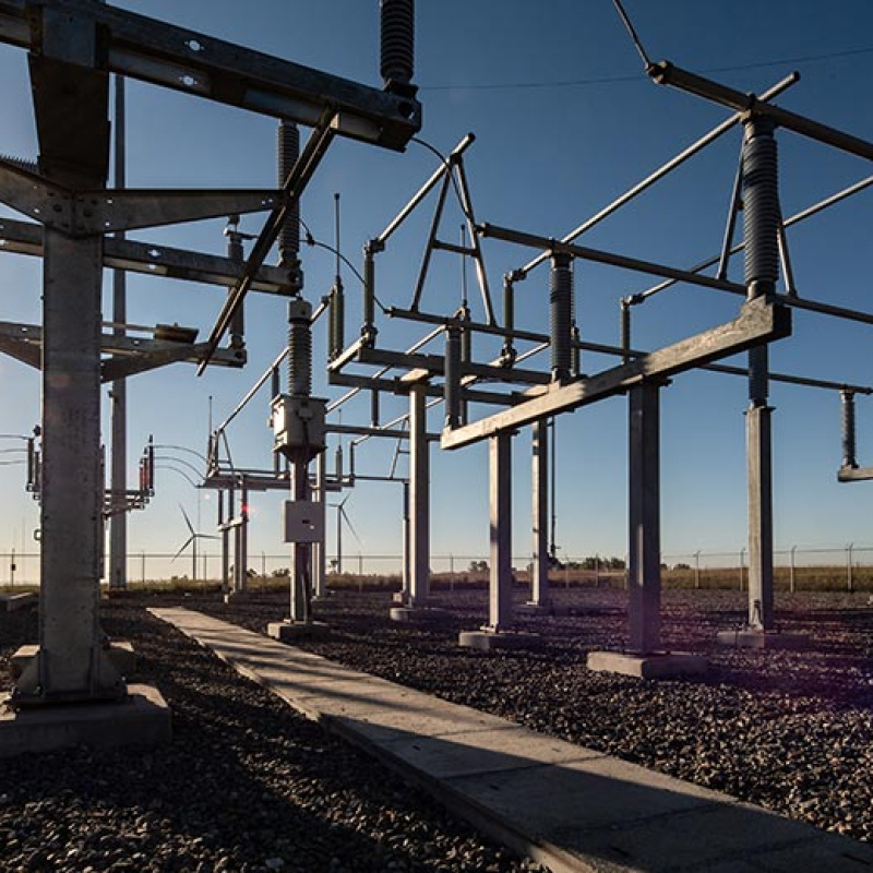 19.9-MW substation in front of a glaring sun and clear blue sky.