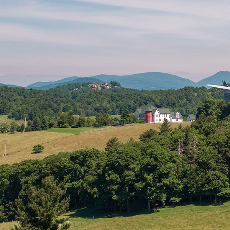 Distributed wind turbine with mountains in the background.