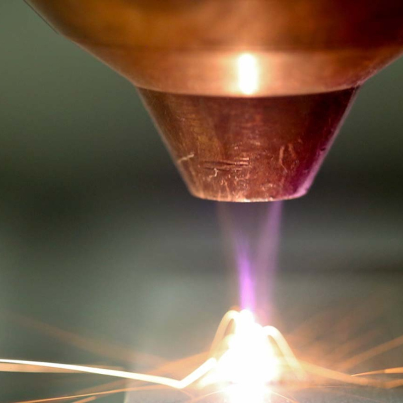 Close up image of a high-temperature concentrated flame that seems to be used to cut or weld.
