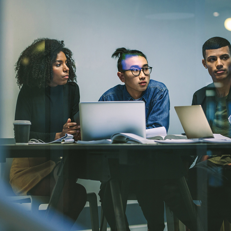 Young people sitting at the table working together.
