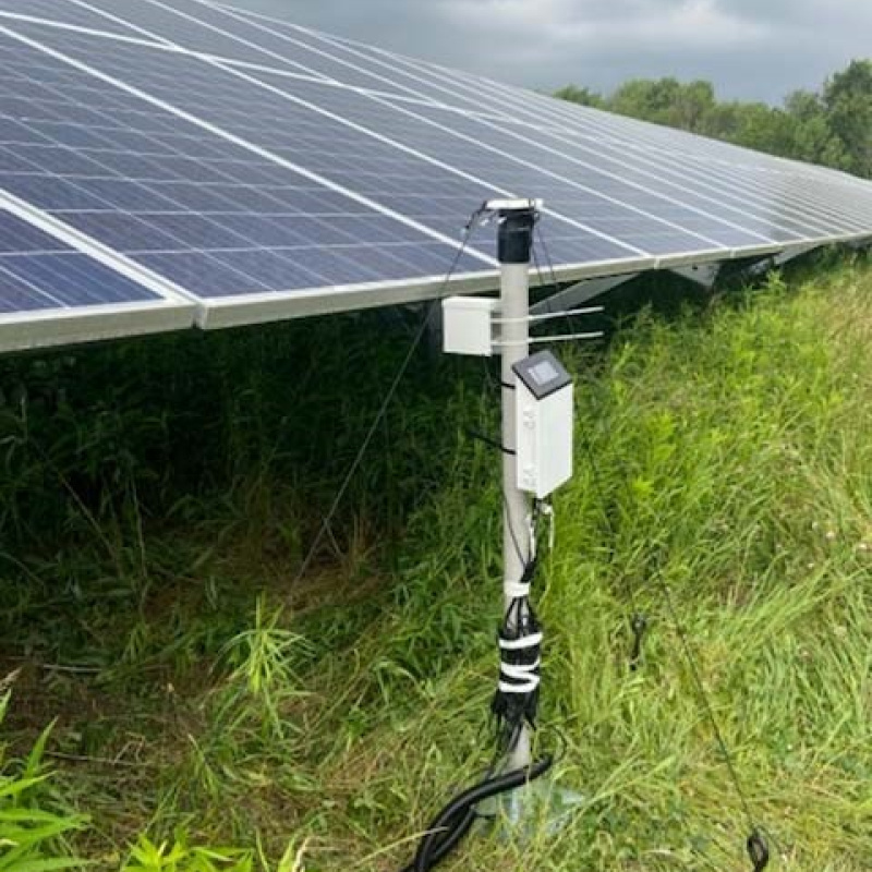 Field testing equipment monitors underground soil moisture at a New York solar facility.