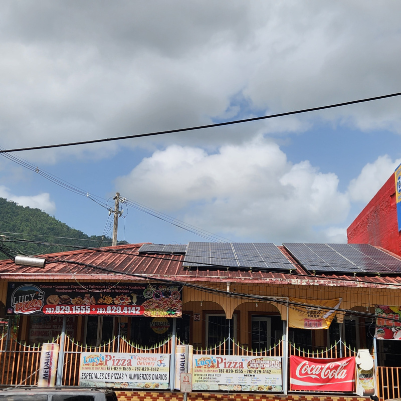 Solar panels can be seen on the rooftop of a pizza restaurant in Puerto Rico. 