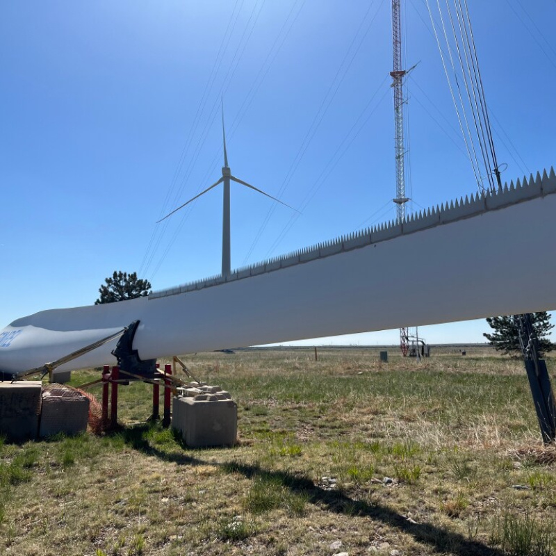 Close-up view of a wind turbine with serrated edges. 