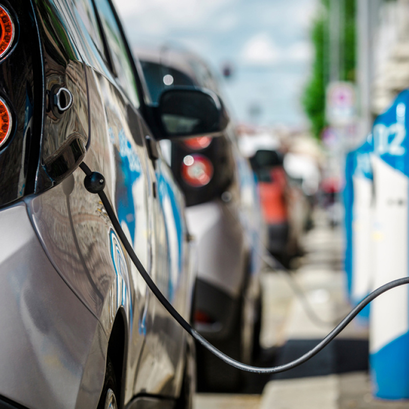 Electric vehicle charged at a charging station.