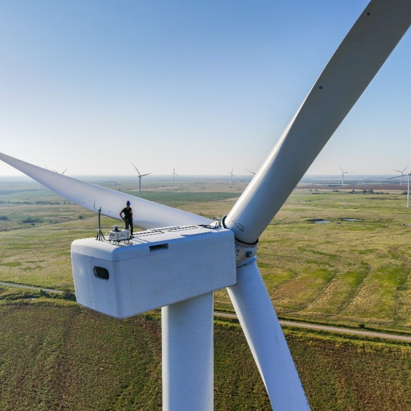 A researcher on top of a wind turbine.