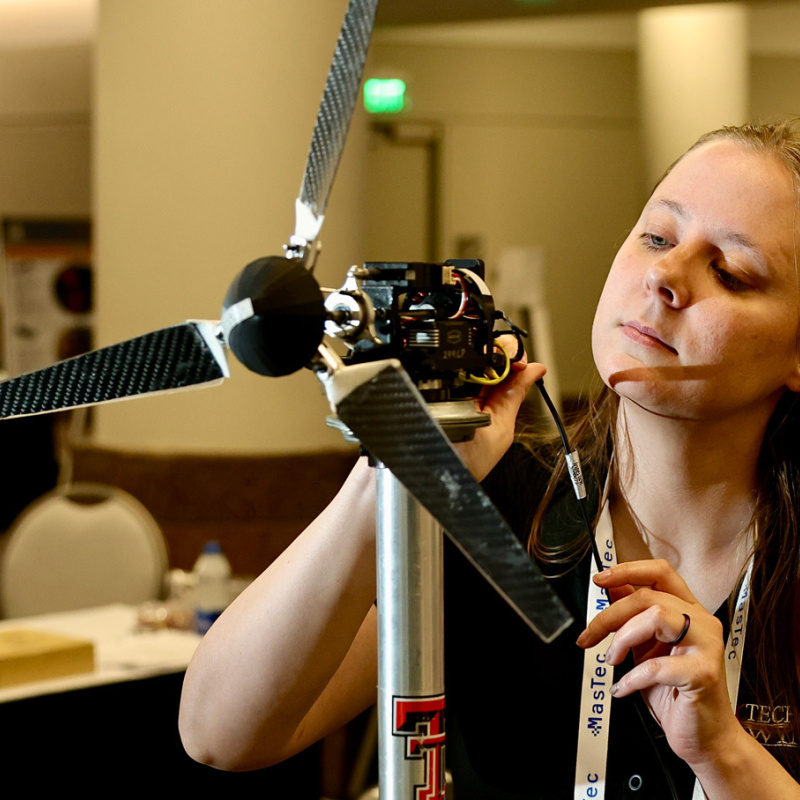 Person working on a wind turbine model