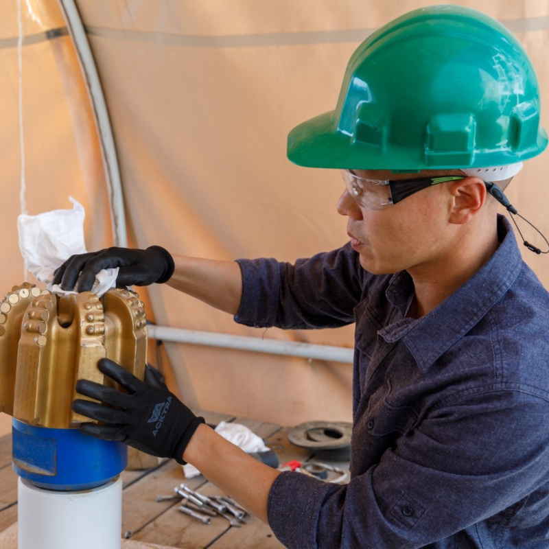 Sandia staff member works with a PDC drill bit