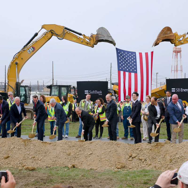 A group of professionals holding shovels while participating in a groundbreaking ceremony at the Portsmouth Side