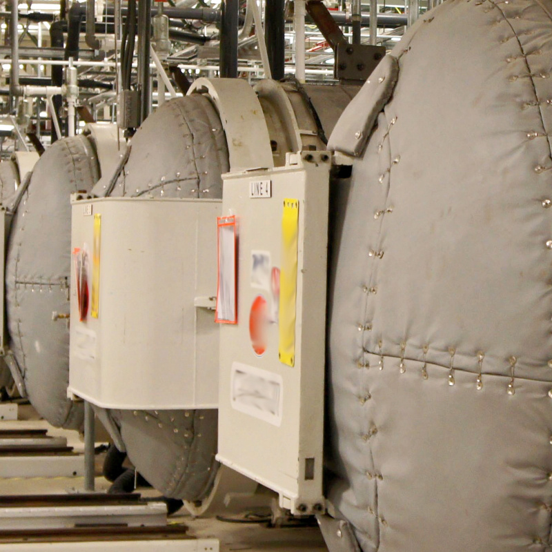 A room full of large grey autoclaves at the Portsmouth Paducah Project Office