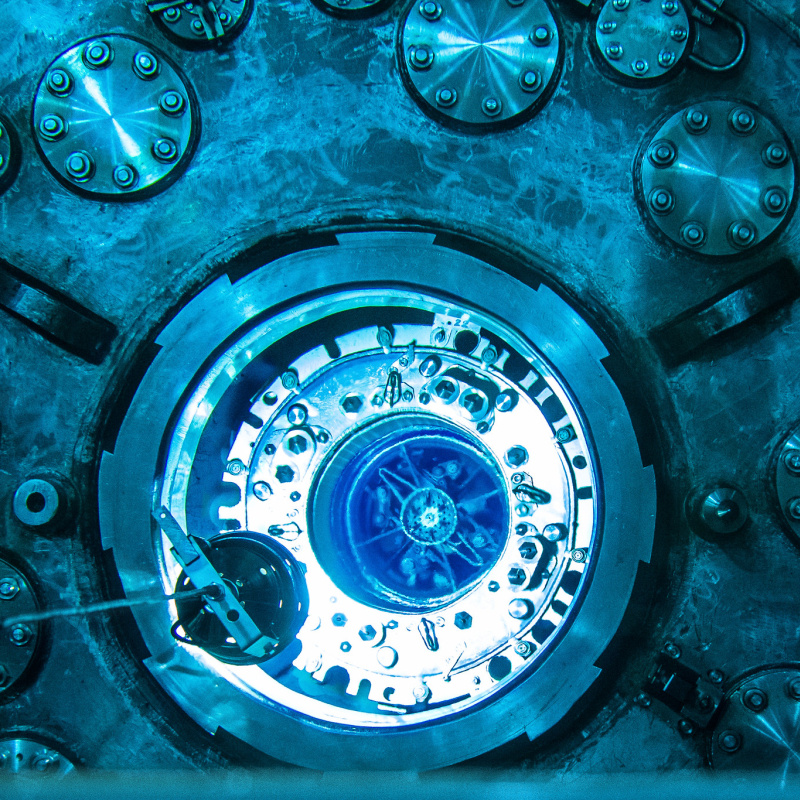 Blue glow from Cherenkov radiation illuminates the submerged reactor core of Oak Ridge National Laboratory’s High Flux Isotope Reactor during refueling.