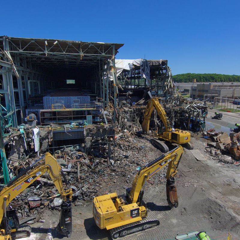 Aerial view of demolition taking place on the corner of a large building