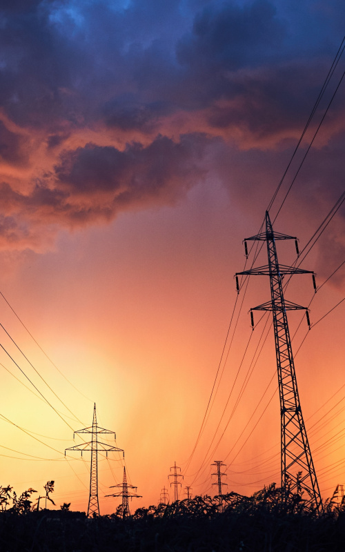 power lines in the midst of a sunset