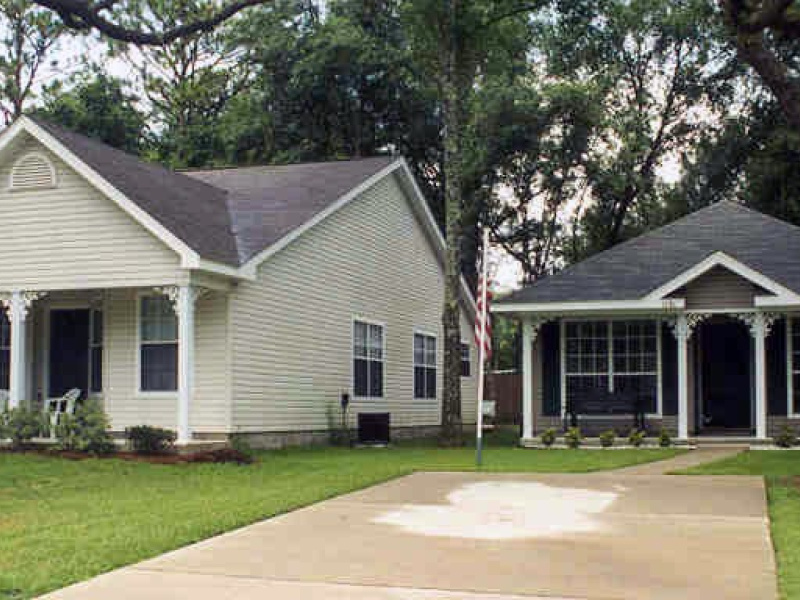 Photo of a house and garage with a driveway leading up to them.