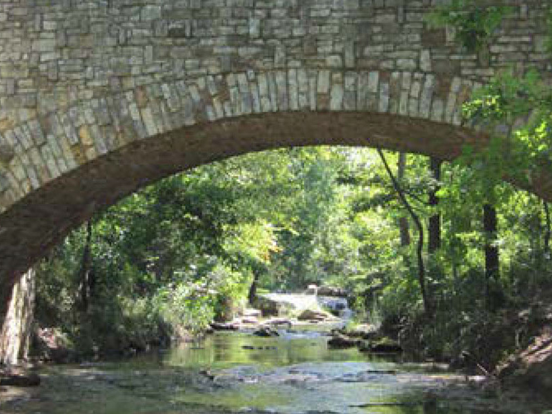 A stone bridge over a creek.