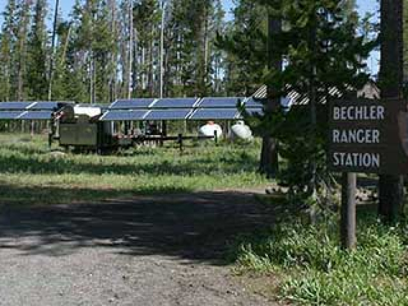 Solar panels set up in the woods of Yellowstone National Park.