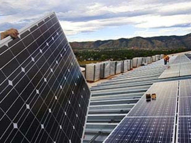 Solar panels with the mountains in the background.